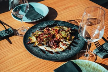 Confit artichokes cooked over charcoal. - Image 1